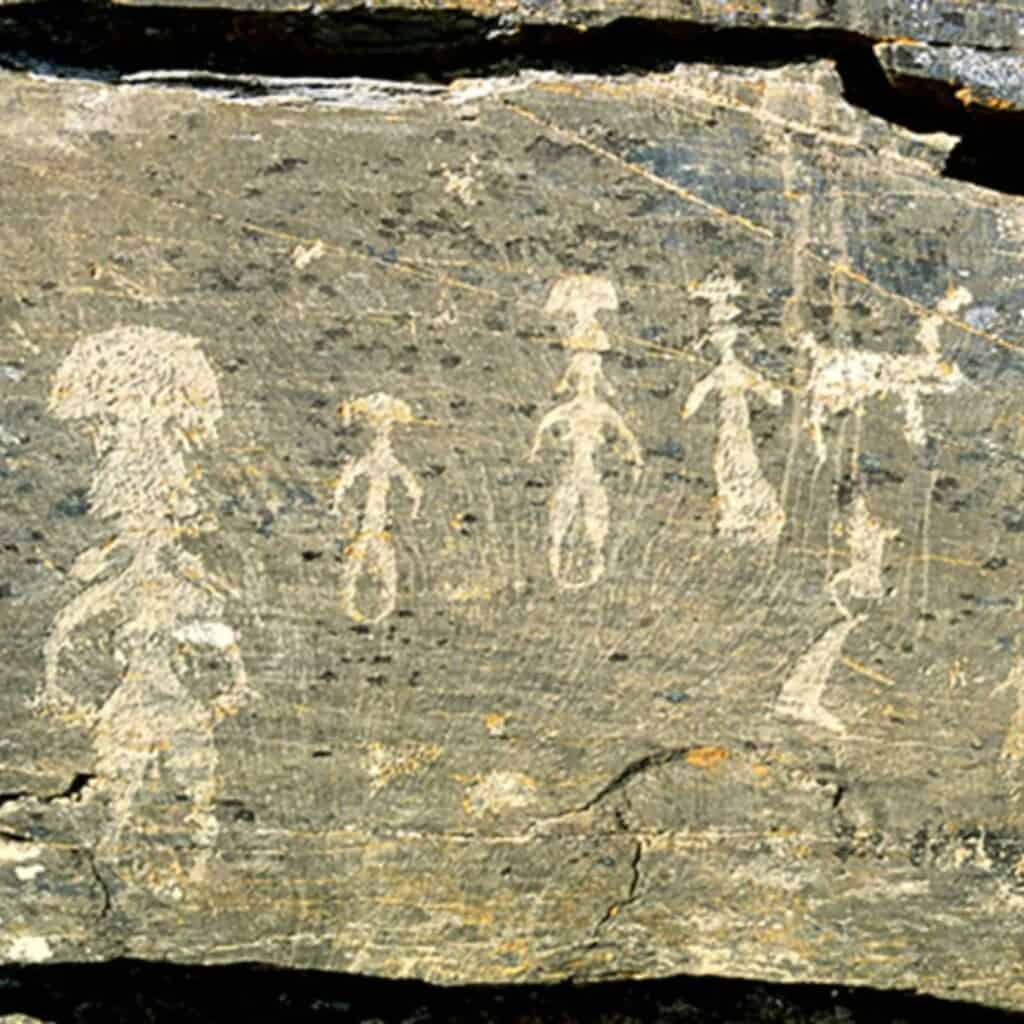 Dancing men and women with huge ‘fly agaric’ mushrooms on their heads.